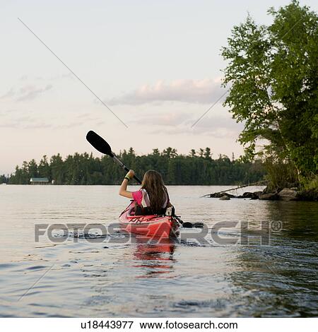 Girl kayaking in a lake, Lake of the Woods, Ontario, Canada View Large Photo Image Stock Photo - Girl kayaking in a lake, Lake of the Woods, Ontario, Canada. Fotosearch