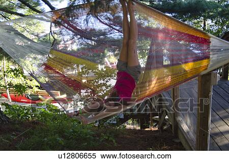 Stock Photography - Girl playing in a hammock, Lake of the Woods, Ontario, Canada. Fotosearch