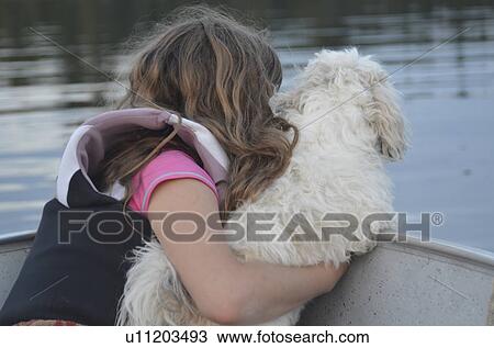Girl sitting with a dog on the boat, Lake of the Woods, Ontario, Canada View Large Photo Image Stock Image - Girl sitting with a dog on the boat, Lake of the Woods, Ontario, Canada. Fotosearch