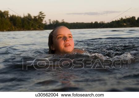 Girl swimming in a lake, Lake of the Woods, Ontario, Canada View Large Photo Image Picture - Girl swimming in a lake, Lake of the Woods, Ontario, Canada. Fotosearch