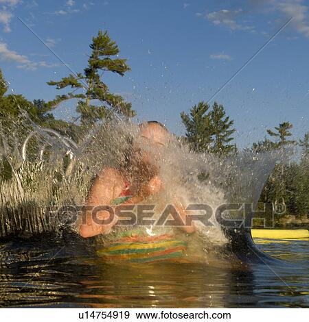 Girl swimming in a lake, Lake of the Woods, Ontario, Canada View Large Photo Image Stock Photo - Girl swimming in a lake, Lake of the Woods, Ontario, Canada. Fotosearch