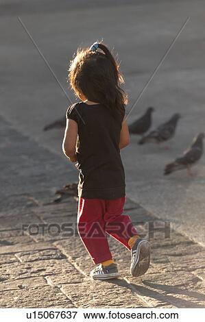 Girl walking near pigeons, Parque Central, Zona 1, Guatemala City, Guatemala View Large Photo Image Stock Photo - Girl walking near pigeons, Parque Central, Zona 1, Guatemala City, Guatemala. Fotosearch
