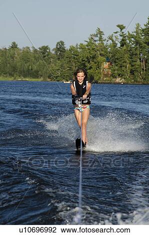 Girl waterskiing in a lake, Lake of the Woods, Ontario, Canada View Large Photo Image Stock Image - Girl waterskiing in a lake, Lake of the Woods, Ontario, Canada. Fotosearch