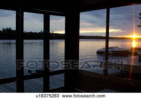 Stock Image - Lake viewed through from the window of a stilt house, Lake of the Woods, Ontario, Canada. Fotosearch