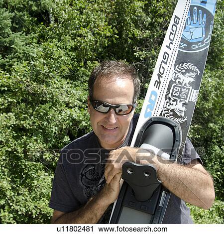 Man holding a water ski, Lake of the Woods, Ontario, Canada View Large Photo Image Stock Image - Man holding a water ski, Lake of the Woods, Ontario, Canada. Fotosearch