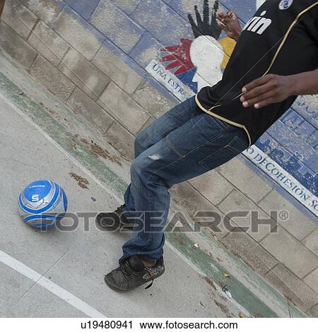Stock Image - Man playing with a soccer ball, Colonia Bethania, Guatemala City, Guatemala. Fotosearch