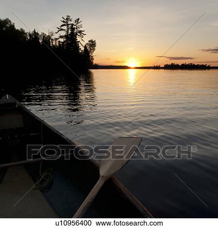 Stock Image - Oar on a canoe in a lake, Lake of the Woods, Ontario, Canada. Fotosearch