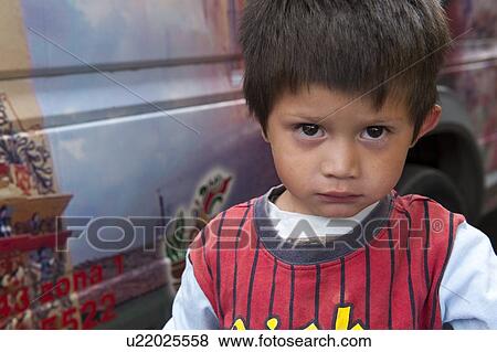 Stock Photo - Portrait of a boy looking serious, Colonia Landivar, Guatemala City, Guatemala. Fotosearch