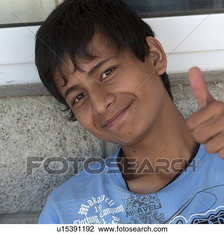 Stock Image - Portrait of a boy showing thumbs up sign, San Jose Pinula, Guatemala City, Guatemala. Fotosearch