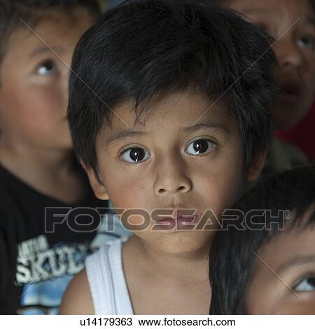 Stock Image - Portrait of a boy with other children, Colonia Bethania, Guatemala City, Guatemala. Fotosearch