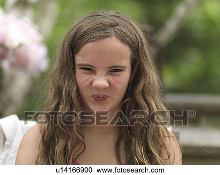 Stock Image - Portrait of a girl making funny face, Lake of the Woods, Ontario, Canada. Fotosearch