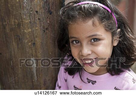 Stock Photo - Portrait of a girl smiling, Colonia Landivar, Guatemala City, Guatemala. Fotosearch