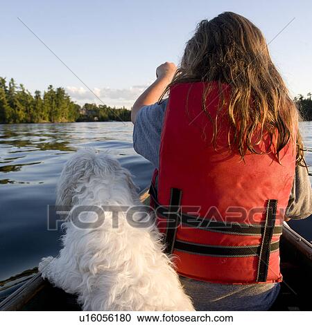 Rear view of a girl sitting on boat with a dog, Lake of the Woods, Ontario, Canada View Large Photo Image Stock Image - Rear view of a girl sitting on boat with a dog, Lake of the Woods, Ontario, Canada. Fotosearch