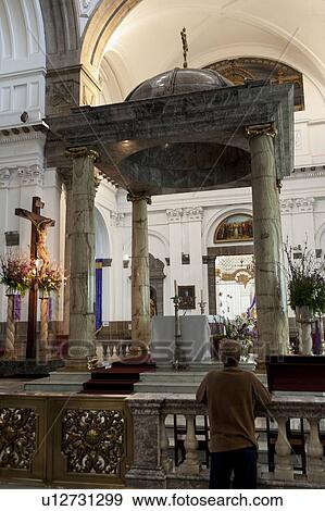 Stock Photo - Rear view of a man praying in a church, Guatemala City, Guatemala. Fotosearch
