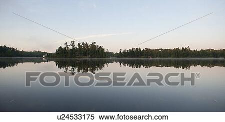 Reflection of trees in a lake, Lake of the Woods, Ontario, Canada View Large Photo Image Stock Photography - Reflection of trees in a lake, Lake of the Woods, Ontario, Canada. Fotosearch