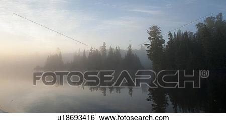Reflection of trees in water during fog, Lake of the Woods, Ontario, Canada View Large Photo Image Stock Photograph - Reflection of trees in water during fog, Lake of the Woods, Ontario, Canada. Fotosearch