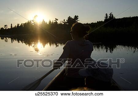 Silhouette of a person rowing a boat, Lake of the Woods, Ontario, Canada View Large Photo Image Stock Image - Silhouette of a person rowing a boat, Lake of the Woods, Ontario, Canada. Fotosearch
