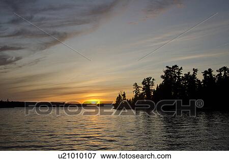 Silhouette of trees at the lakeside, Lake of the Woods, Ontario, Canada View Large Photo Image Stock Photo - Silhouette of trees at the lakeside, Lake of the Woods, Ontario, Canada. Fotosearch