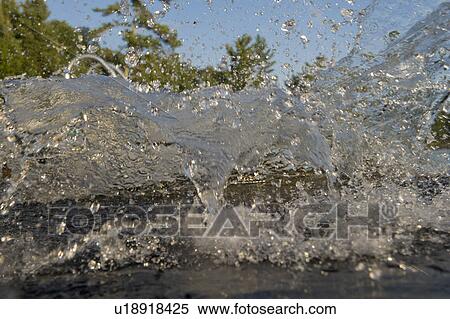 Stock Photography - Splash of water over a lake, Lake of the Woods, Ontario, Canada. Fotosearch