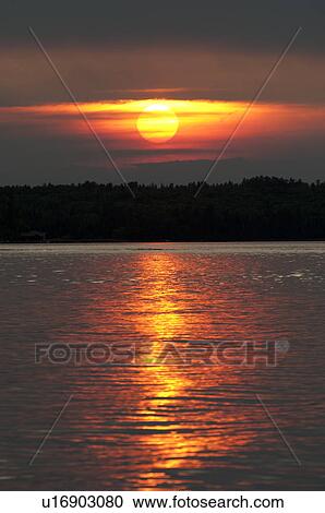 Stock Image - Sunset over the lake, Lake of the Woods, Ontario, Canada. Fotosearch