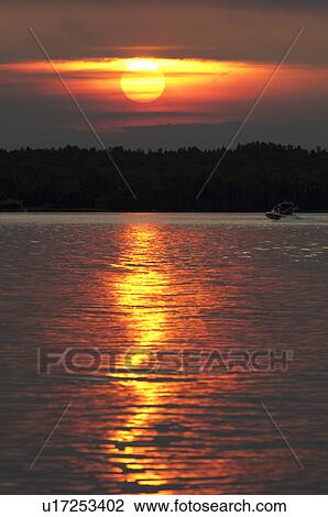 Stock Image - Sunset over the lake, Lake of the Woods, Ontario, Canada. Fotosearch