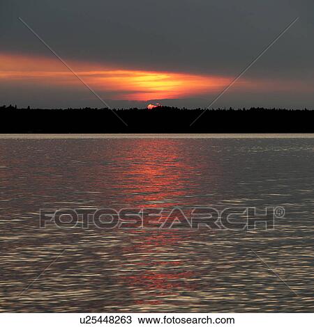 Stock Image - Sunset over the lake, Lake of the Woods, Ontario, Canada. Fotosearch