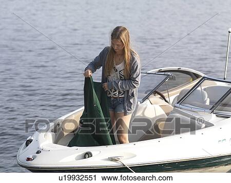 Teenage girl standing on a motorboat, Lake of the Woods, Ontario, Canada View Large Photo Image Stock Image - Teenage girl standing on a motorboat, Lake of the Woods, Ontario, Canada. Fotosearch