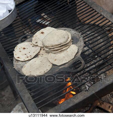 Tortilla being baked on a barbecue grill, Zona 3, Guatemala City, Guatemala View Large Photo Image Picture - Tortilla being baked on a barbecue grill, Zona 3, Guatemala City, Guatemala. Fotosearch