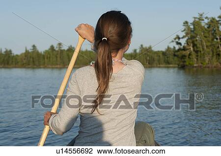 Woman rowing a boat in a lake, Lake of the Woods, Ontario, Canada View Large Photo Image Stock Image - Woman rowing a boat in a lake, Lake of the Woods, Ontario, Canada. Fotosearch