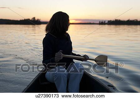 Woman rowing a boat in a lake, Lake of the Woods, Ontario, Canada View Large Photo Image Stock Image - Woman rowing a boat in a lake, Lake of the Woods, Ontario, Canada. Fotosearch