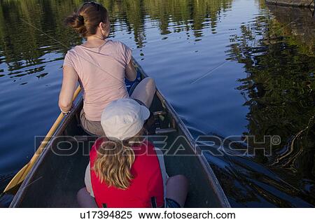 Woman rowing a boat with her daughter, Lake of the Woods, Ontario, Canada View Large Photo Image Stock Photography - Woman rowing a boat with her daughter, Lake of the Woods, Ontario, Canada. Fotosearch