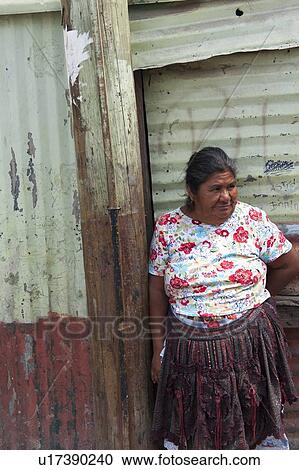 Woman standing in front of a house in slum area, Colonia Landivar, Guatemala City, Guatemala View Large Photo Image Stock Image - Woman standing in front of a house in slum area, Colonia Landivar, Guatemala City, Guatemala. Fotosearch