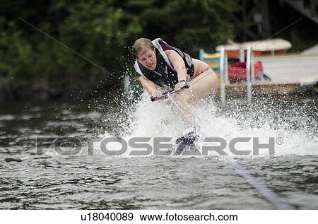 Stock Photo - Woman waterskiing in a lake, Lake of the Woods, Ontario, Canada. Fotosearch
