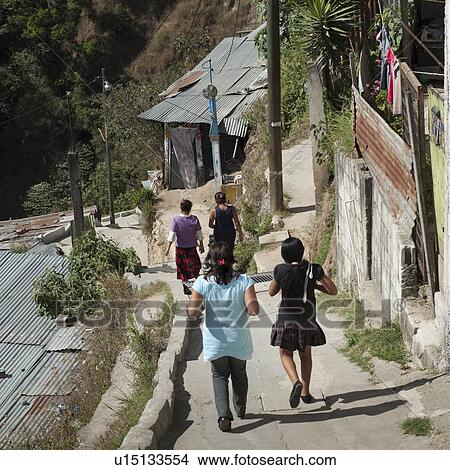Picture - Women walking on stepped walkway, Colonia Bethania, Guatemala City, Guatemala. Fotosearch