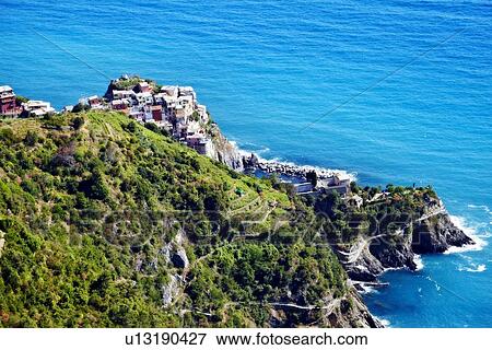 Stock Photo - Aerial view of coastal city on hillside. Fotosearch