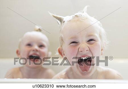 Stock Image - Babies laughing in bath. Fotosearch