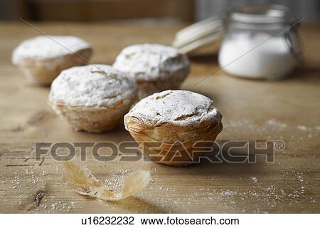 Stock Image - Baked puff pastries on table. Fotosearch