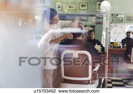 Barber working on client in shop View Large Photo Image Stock Image - Barber working on client in shop. Fotosearch