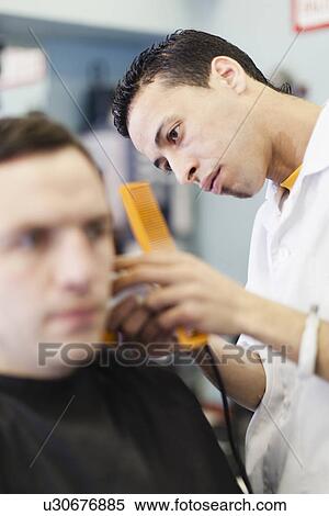 Barber working on client in shop View Large Photo Image Stock Photography - Barber working on client in shop. Fotosearch