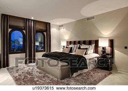Bed and windows in modern bedroom View Large Photo Image Stock Photography - Bed and windows in modern bedroom. Fotosearch