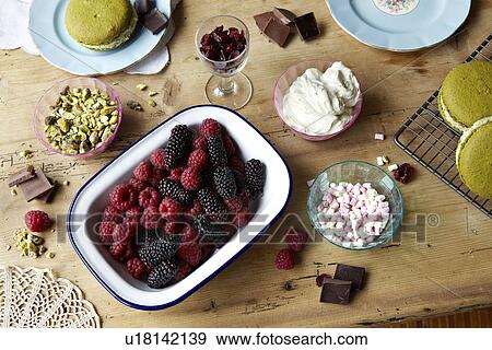 Stock Photo - Berries, chocolate, pudding and nuts. Fotosearch