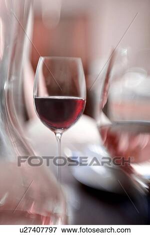 Stock Photo - Blurred view of glasses of wine. Fotosearch