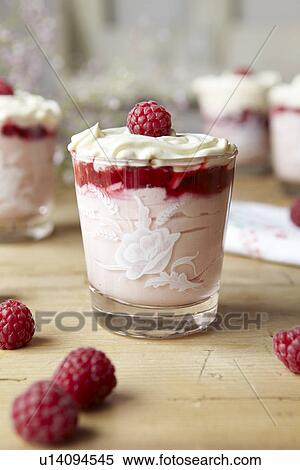 Stock Photography - Bowl of pudding with fruit and cream. Fotosearch