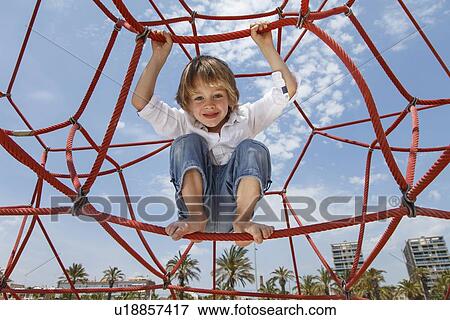 Boy playing on ropes on beach View Large Photo Image Stock Photo - Boy playing on ropes on beach. Fotosearch
