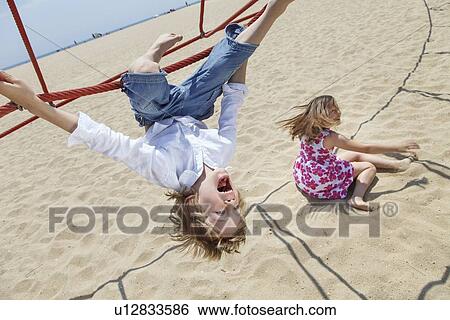 Boy playing on ropes on beach View Large Photo Image Stock Photograph - Boy playing on ropes on beach. Fotosearch