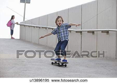 Boy riding skateboard on ramp View Large Photo Image Stock Photography - Boy riding skateboard on ramp. Fotosearch
