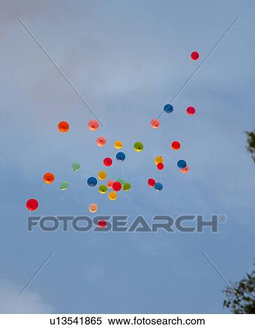 Stock Photography - Bunch of balloons floating in sky. Fotosearch