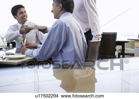 Picture - Business people having lunch together. Fotosearch