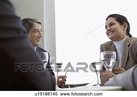 Stock Photography - Business people having lunch together. Fotosearch