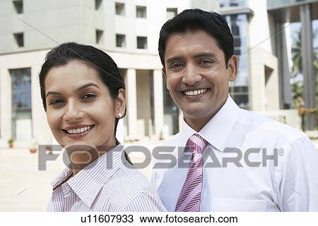 Stock Image - Business people smiling together. Fotosearch